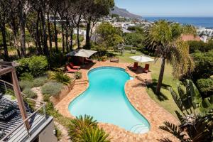 an overhead view of a swimming pool with the ocean in the background at 42 On Strathmore in Cape Town