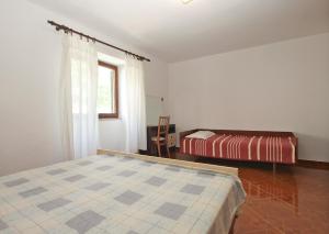 Postel nebo postele na pokoji v ubytování Apartments Luciano 1728