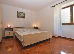 Postel nebo postele na pokoji v ubytování Apartments Luciano 1728