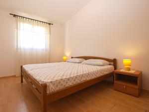 Postel nebo postele na pokoji v ubytování Apartments Luciano 1728