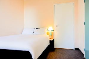 Postel nebo postele na pokoji v ubytování ibis Lyon Est Bron