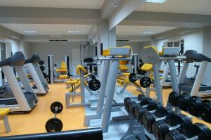 a gym with rows of tread machines and weights at Premier Hotel in Krasnodar