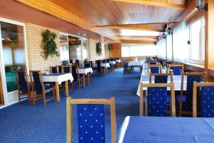 una sala da pranzo con tavoli e sedie in un ristorante di Hotel Imzit Dobrinja a Sarajevo