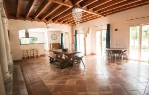 a large living room with a table and chairs at La villa bella in Abzac