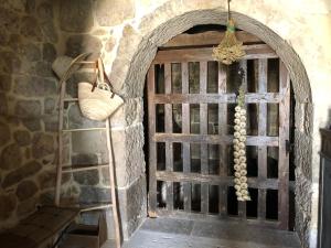 a wooden door leading to a room with a stone wall at Emebed Posada in Castrojeriz