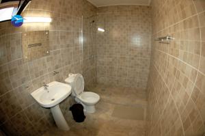 a bathroom with a toilet and a sink at Casa Sagrada in Eforie Nord +27 photos
