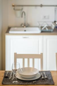a table with a plate and a glass on it at Agriturismo Rosa Antica in Monte San Vito +189 photos
