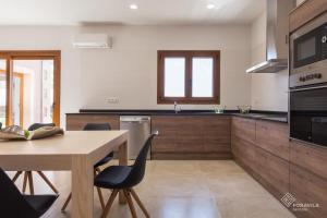 a kitchen with a wooden table and a wooden counter top at Moli den Sion in Sa Pobla