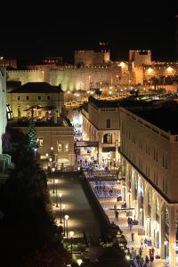 a view of a city at night with lights at Mamilla Design Apartments in Jerusalem