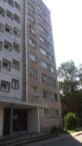 a tall building with many windows on the side of it at Отдельная комната в Юрмале in Jūrmala