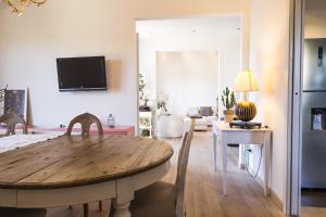 a living room with a wooden table in a room at La Rosa dei Sensi Luxury Villa Apt 1 in Montecarlo