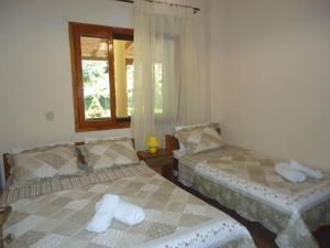 a bedroom with two beds and a window at Garden beach house in Paralia Panteleimonos