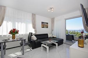 a living room with a couch and a table at Villa Inis in Makarska