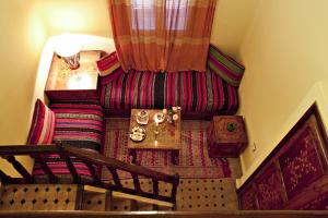 a living room with a couch and a table at Riad Maison Du Sud in Essaouira