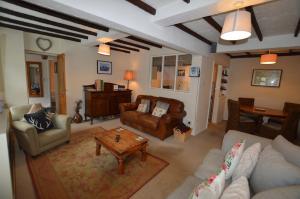 a living room with a couch and chairs and a table at Fox Barn in Staveley