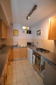 a kitchen with a sink and a stove top oven at Fox Barn in Staveley