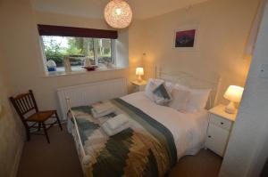 a bedroom with a bed with pillows and a window at Fox Barn in Staveley