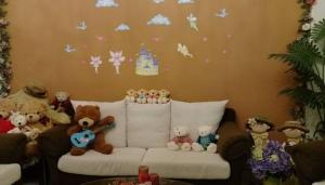 a group of stuffed teddy bears sitting on a couch at sweet home B&B in Hualien City