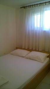 Postel nebo postele na pokoji v ubytování Apartments Zovko