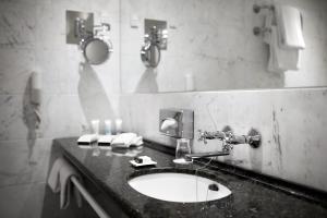 a bathroom with a sink and a mirror at Phoenix Copenhagen in Copenhagen