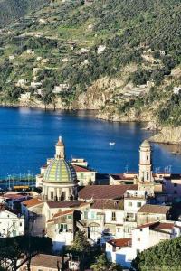 a group of buildings in front of a body of water at La Califfa in Vietri sul Mare