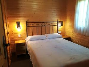 a bedroom with a large bed in a wooden room at Cabañas los Pinos Arroyo Frio in Arroyo Frio +104 photos