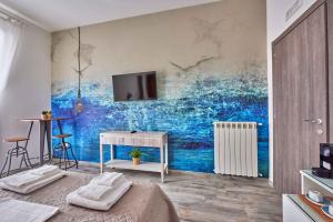 a bedroom with a wall with a painting of the ocean at Il Chiattillo in Naples