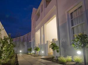 a white building with lights on the side of it at Kenjockity Self Catering Apartments in Hermanus