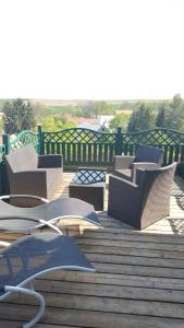 a group of chairs and tables on a deck at Landhotel BurgenBlick Garni & Tagungshotel in Erfurt