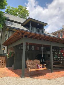 un porche con una silla mecedora frente a una casa en Black Lantern Inn, en Roanoke