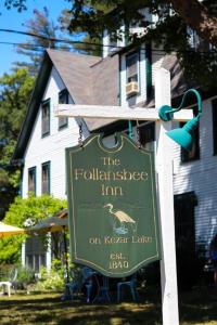 a sign for the football village inn in front of a house at Follansbee Inn in North Sutton