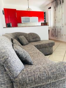 a couch sitting in a living room with red cabinets at Sea view Apartment, Todorovic in Kotor