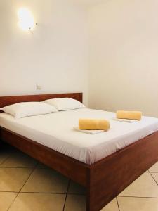 a bed with two towels on top of it at Sea view Apartment, Todorovic in Kotor