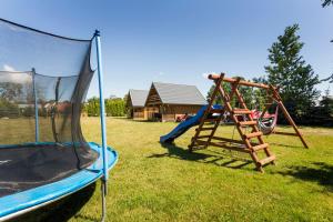 a playground with a slide and a swing set at U Marleny in Ustka