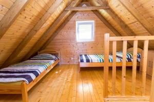 a bedroom with two beds in a log cabin at U Marleny in Ustka +13 photos