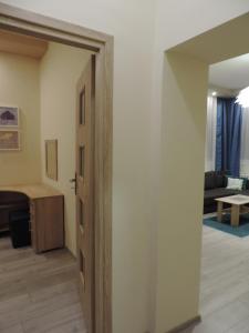 an open door in a room with a living room at Apartament Blue in Krosno