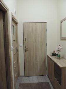 a wooden door in a room with a desk at Apartament Blue in Krosno