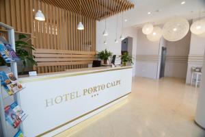 a hotel porto clinic lobby with a counter and potted plants at Hotel Porto Calpe in Calpe