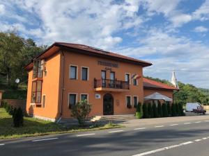 a building on the side of a road at Pensiunea Crimar in Ilteu