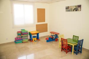 a room with colorful chairs and tables and a window at Hotel Porto Calpe in Calpe