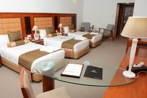 Ένα ή περισσότερα κρεβάτια σε δωμάτιο στο Marigold Hotel