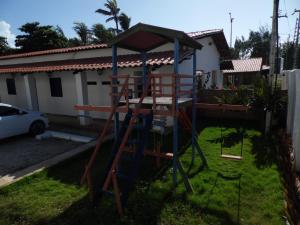 a playground with a ladder in a yard at Hotel Praia do Futuro in Fortaleza