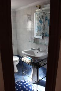 a bathroom with a sink and a toilet at Siviri Apartment in Blu in Siviri