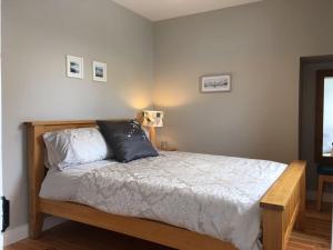 a bedroom with a bed with two pillows on it at Village Way Apartments in Kincasslagh