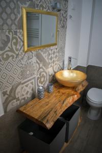 a bathroom with a wooden counter with a sink and a mirror at La Girandola in Palermo