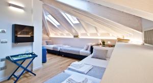 a living room with a couch and a tv at Manzoni 124 Bed&Relax in Esine