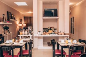 a dining room with tables and chairs and a tv at Hotel Solano in Santiago del Estero