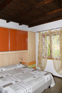 a bedroom with a large bed and a window at Villa Miriam in Monte Nai
