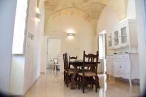 a dining room with a table and chairs at Tenuta Buonasorte in Torre dell'Orso +20 photos