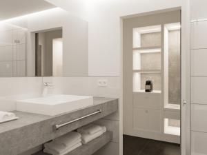 a white bathroom with a sink and a mirror at smartel at The Unbrexit in Ahaus